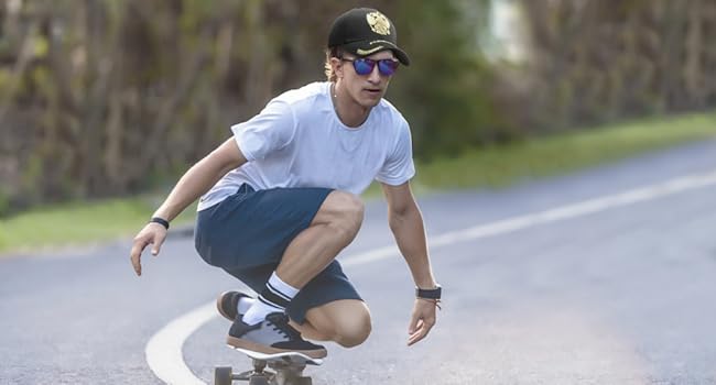 Boys in gold embroidered baseball caps skateboarding. Looks cool.