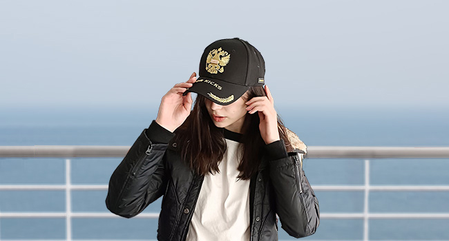 The young woman is wearing a gold embroidered hat. Showing off her elegance.