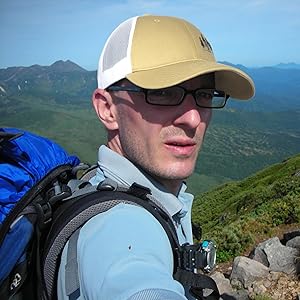 a man wearing trucker cap land against sky