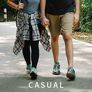 A man in overalls and a woman walking leisurely on the road. black cargo shorts mens shorts cargo