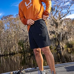 Men wears huk creekbed shorts while fishing