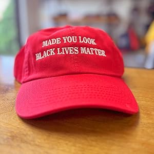 Function Red Made you Look Black Lives Matter Dad Hat on wood table